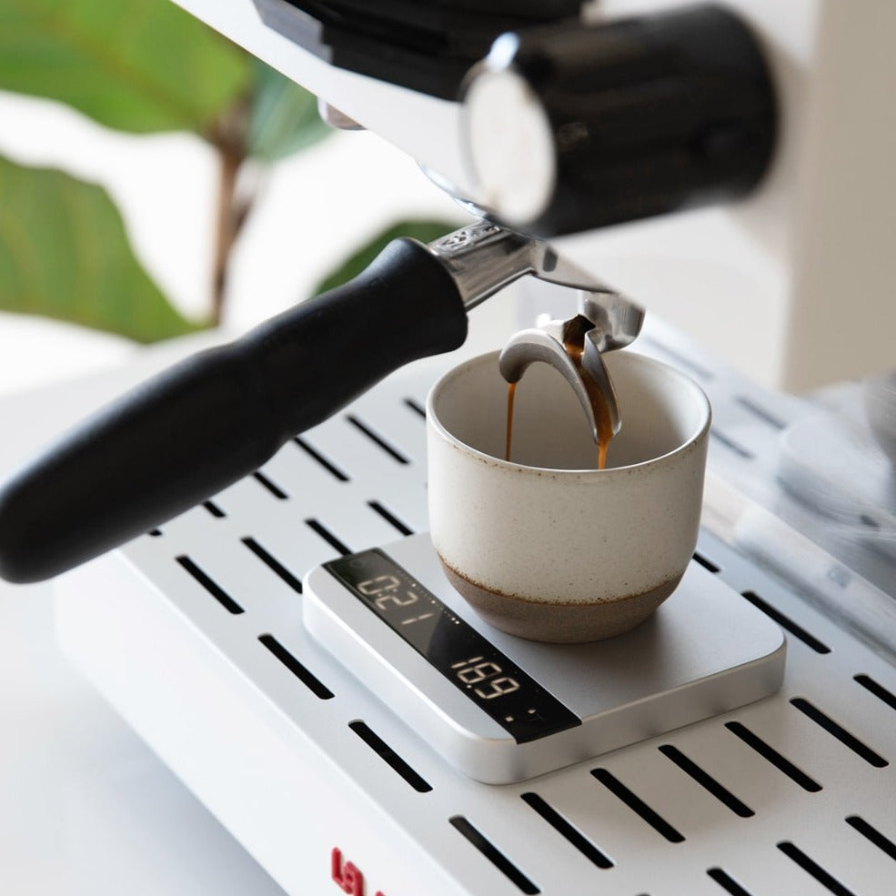 Acaia Lunar 2021 Silver Scale on espresso machine with coffee brewing.